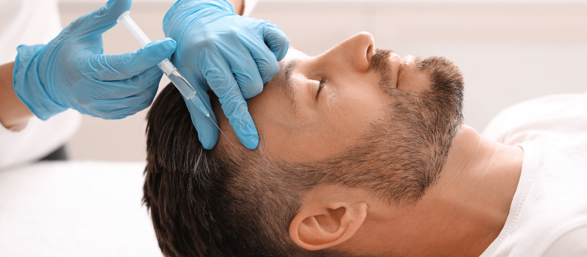 Male getting hair growth treatment