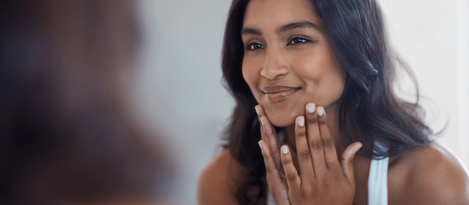 a woman looking in the mirror smiling